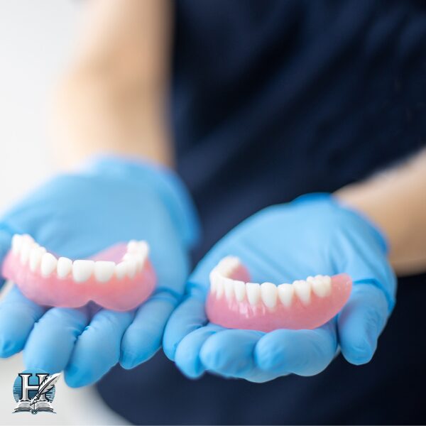 a person holding a pair of fake teeth