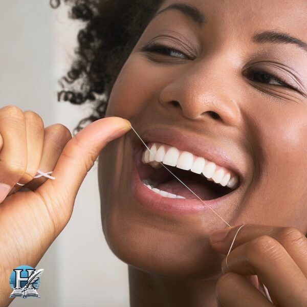 a woman flossing her teeth